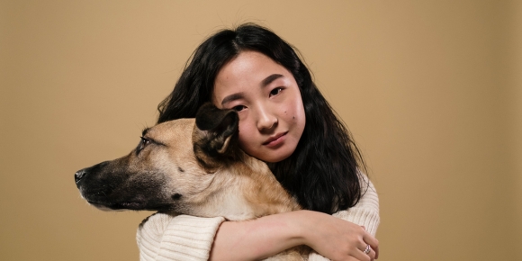 female holding large brown dog