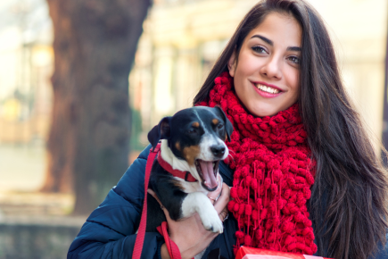 MKVG-why-take-your-dog-christmas-shopping lady christmas shopping with dog under her arm
