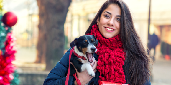 MKVG-why-take-your-dog-christmas-shopping lady christmas shopping with dog under her arm